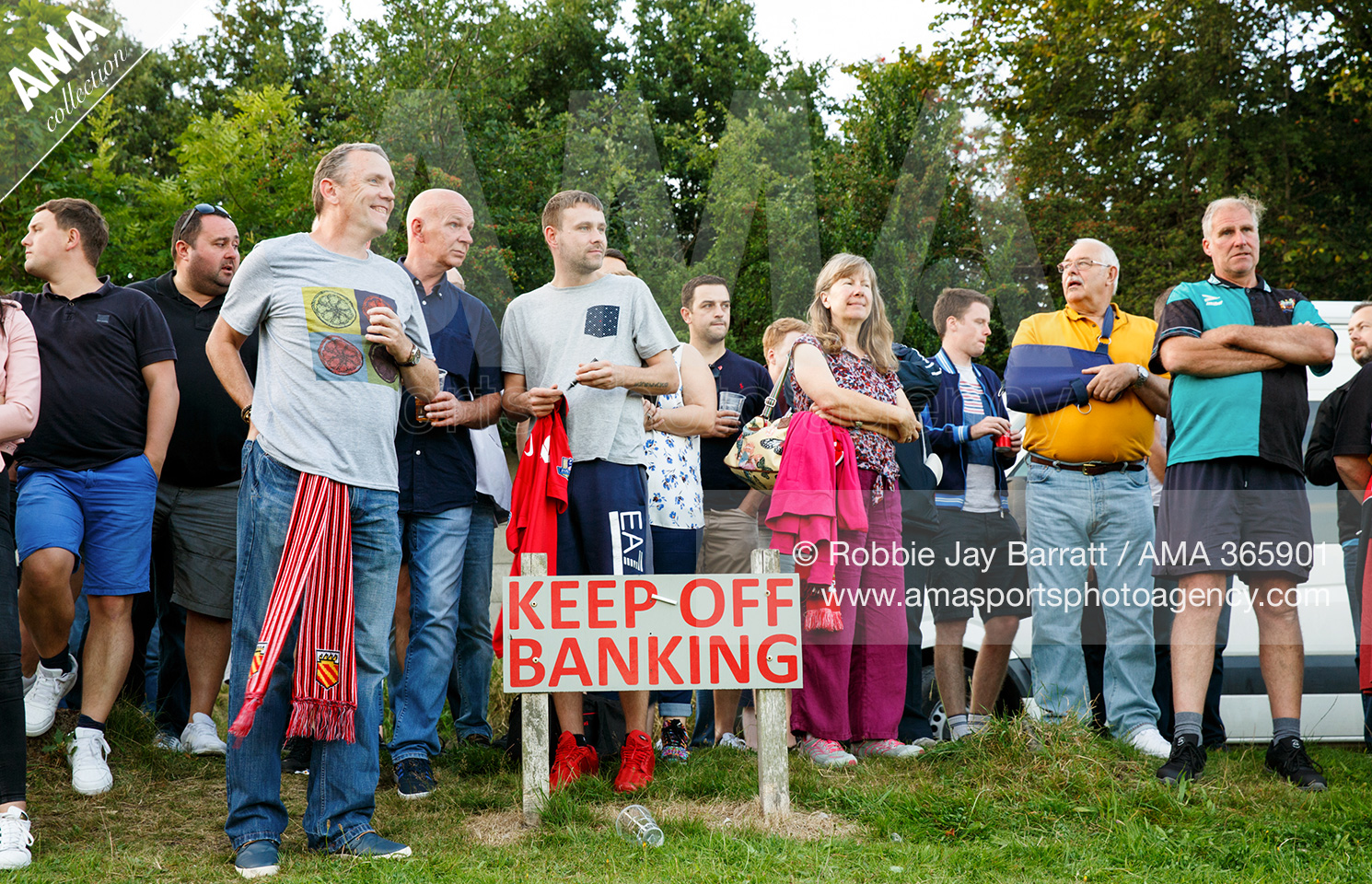 Vanarama National League North - Salford City v FC United of Manchester - Fans stand on a bank Moor Lane stadium, home of Salford City in front of a sign saying Keep Off Banking